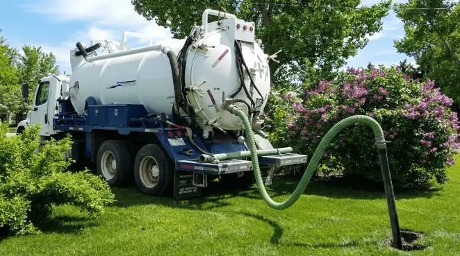 Professional vacuum truck performing residential drainage and septic maintenance in Knoxville, TN