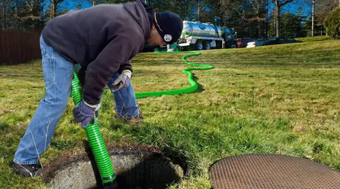 Service technician performing residential septic pumping and drainage maintenance in Knoxville, TN